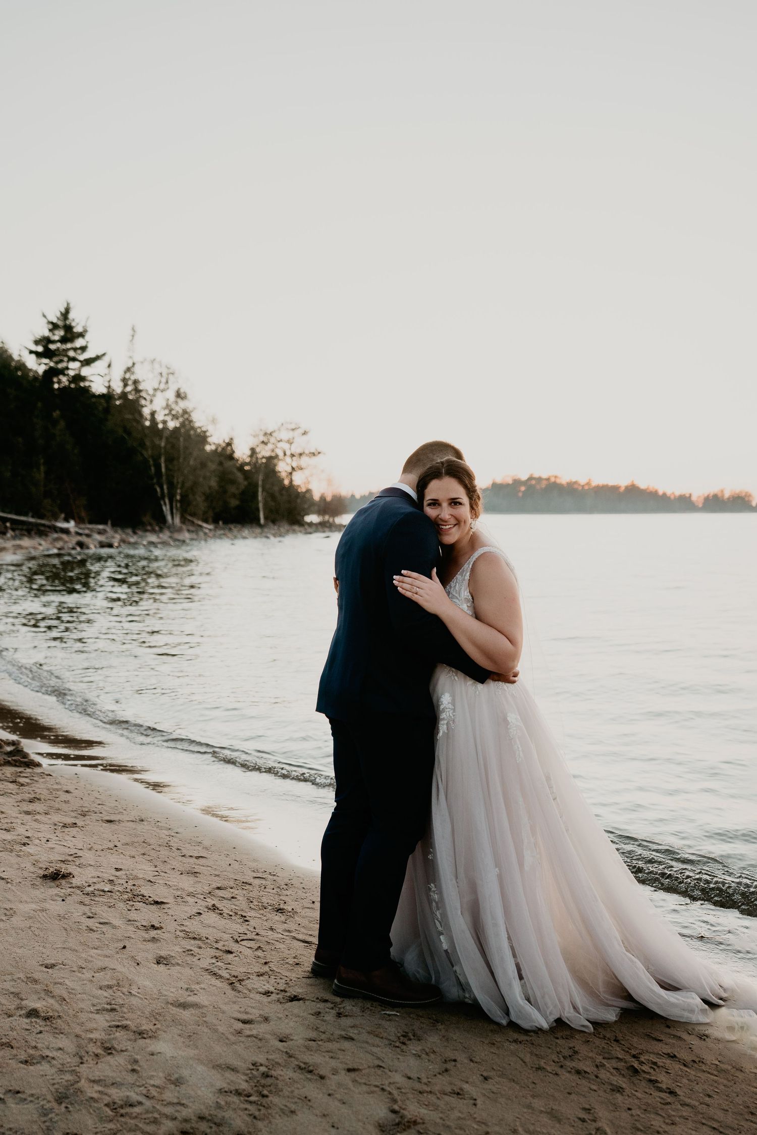bride and groom at the beach in Lake Huron
