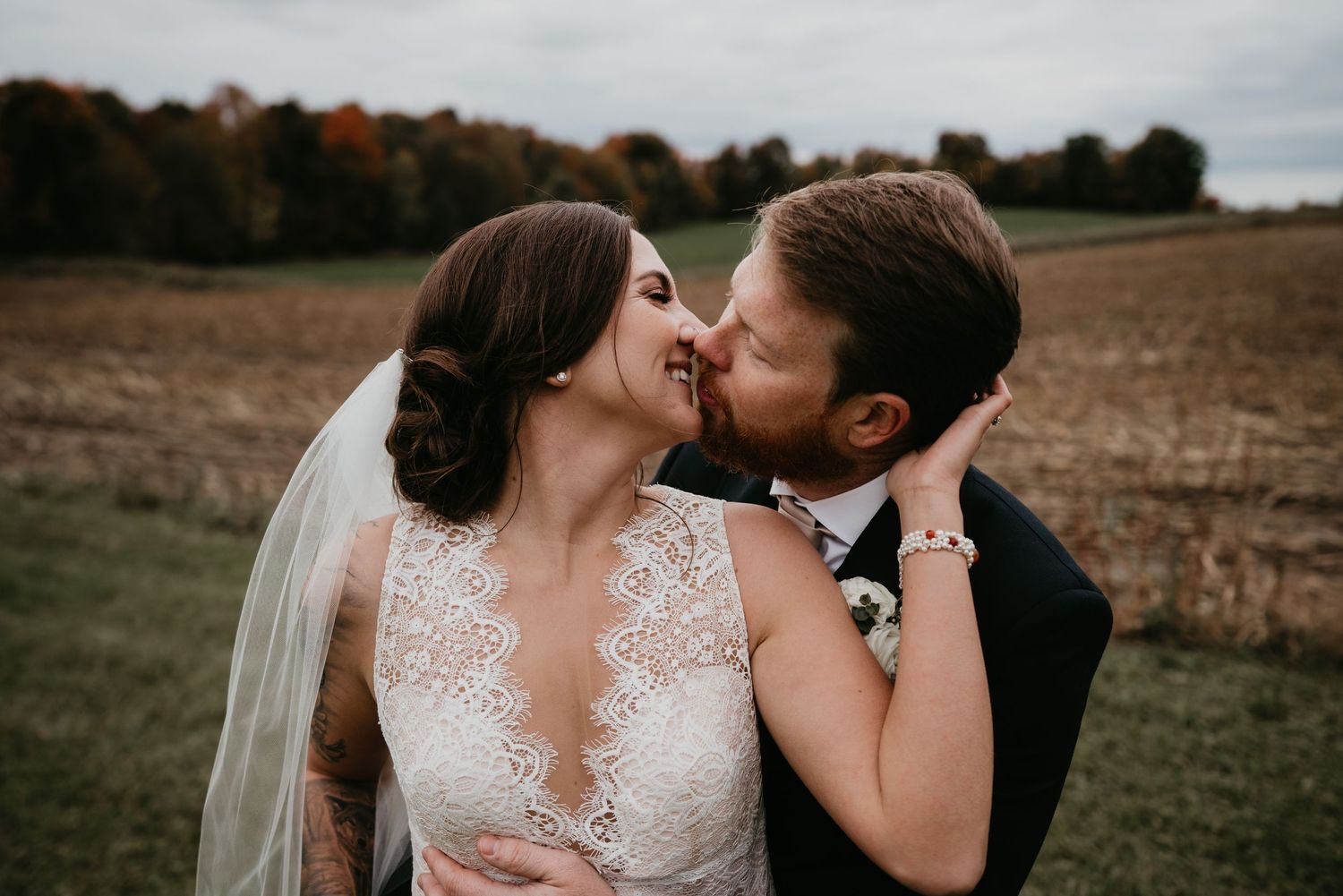 bride and groom kiss in field in Holstein Ontario