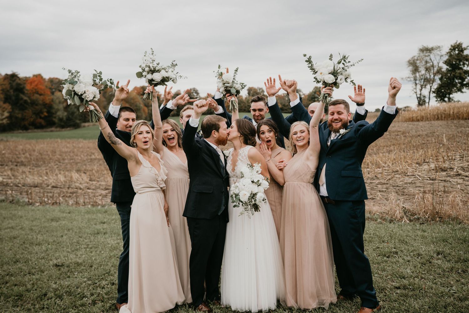 wedding party with bride and groom cheer