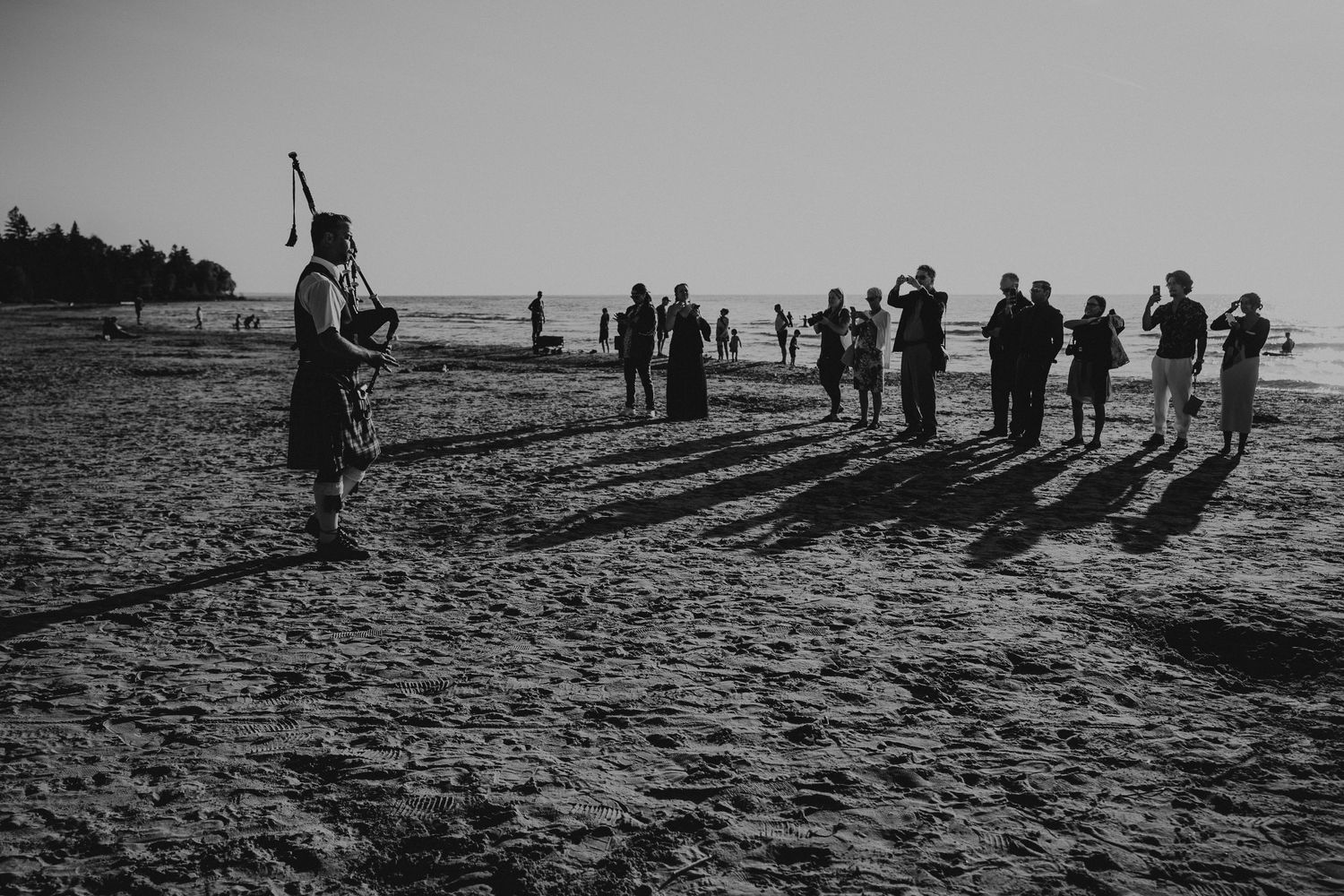 bag piper playing for guests on a beach