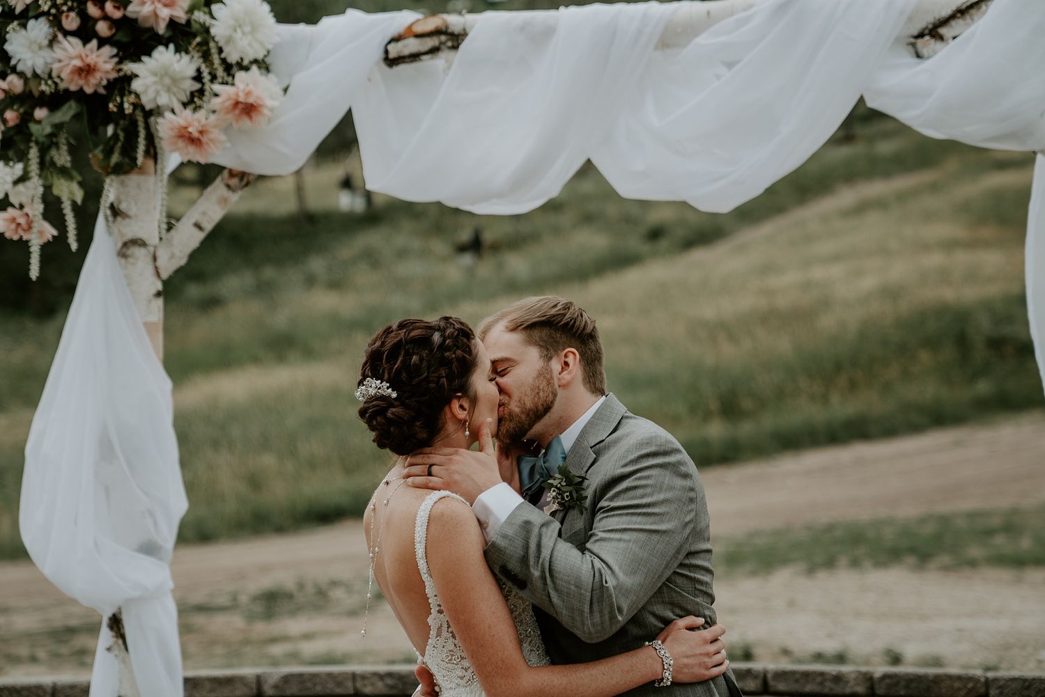 Ceremony first kiss bride and groom at Ski resort in Blue Mountains Ontario