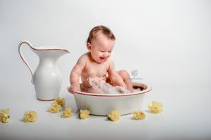 one year old baby photoshoot; Cake Smash photographer; Lexington, SC baby photos; Baby in milk bath & flowers; SC Studio