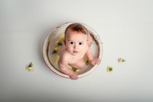 one year old baby photoshoot; Cake Smash photographer; Lexington, SC baby photos; Baby in milk bath with flowers