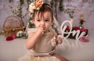 Baby girl flower boho Cake Smash session; eating cake portrait studio Lexington, SC; best children's photographer SC