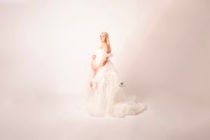 Blonde pregnant mom wearing white maternity gown with ruffles & tulle; Lexington, SC portrait studio; maternity session
