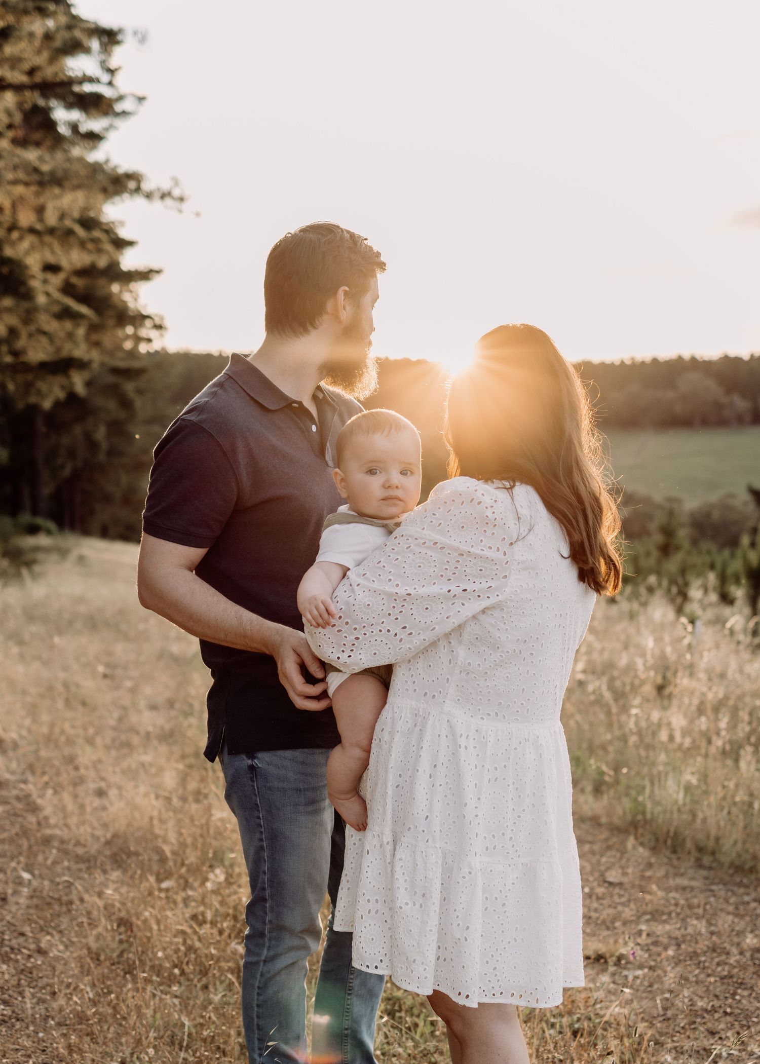Adelaide family photography — family cuddling and watching the sunset during a session in Kuipto Forest.