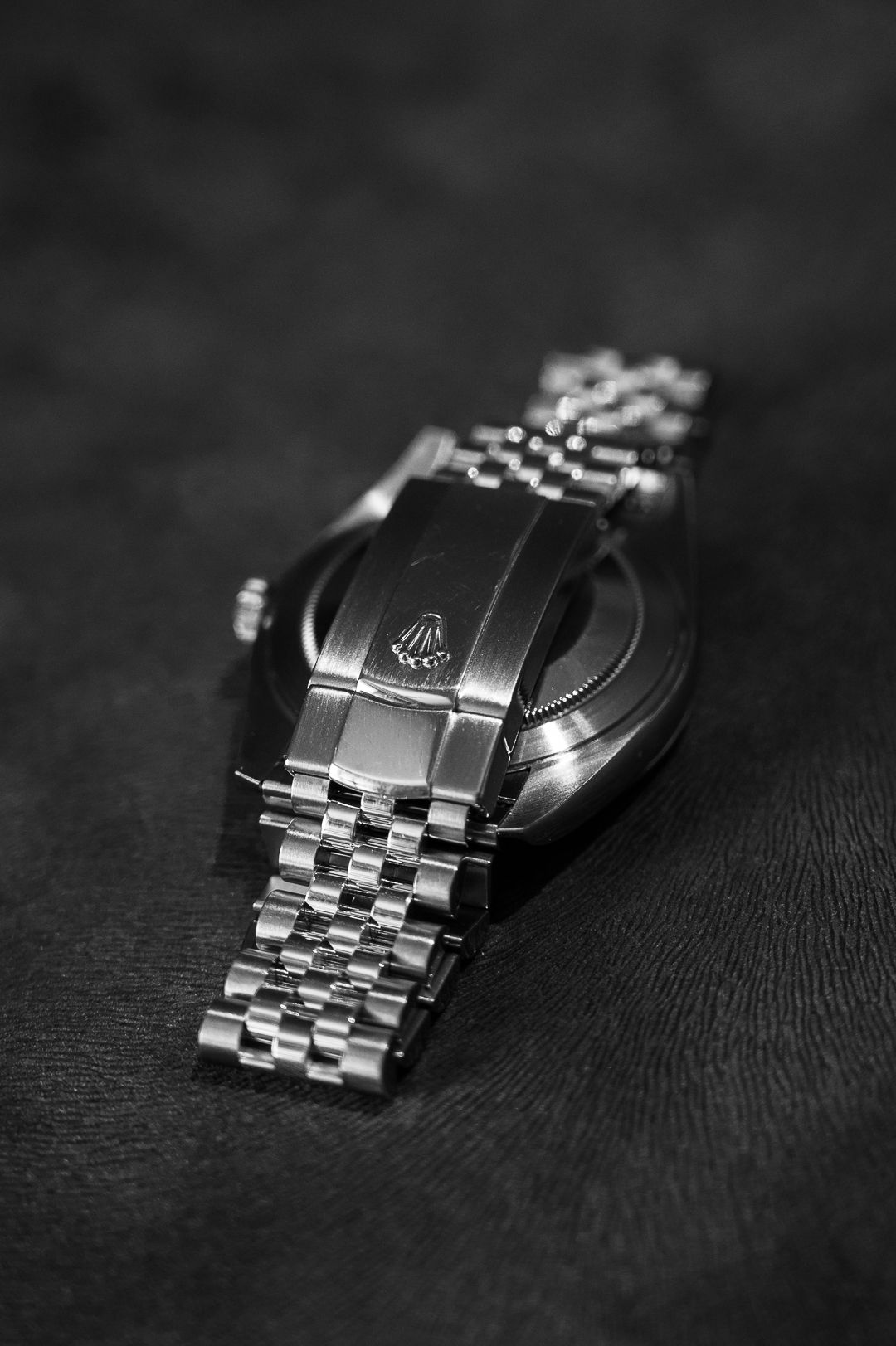 Close-up of Rolex jubilee bracelet clasp and band in black and white.