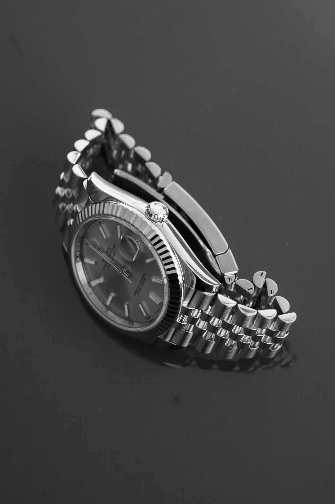 Stainless steel Rolex watch with jubilee bracelet photographed from side angle.