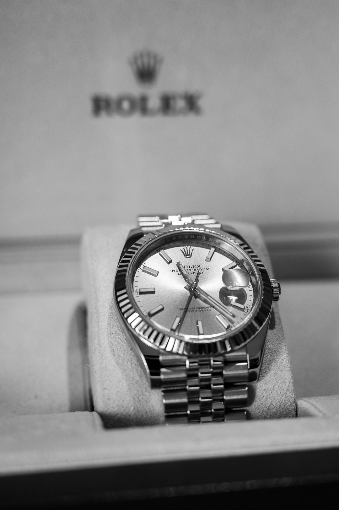 Stainless steel Rolex Datejust watch with fluted bezel on display.