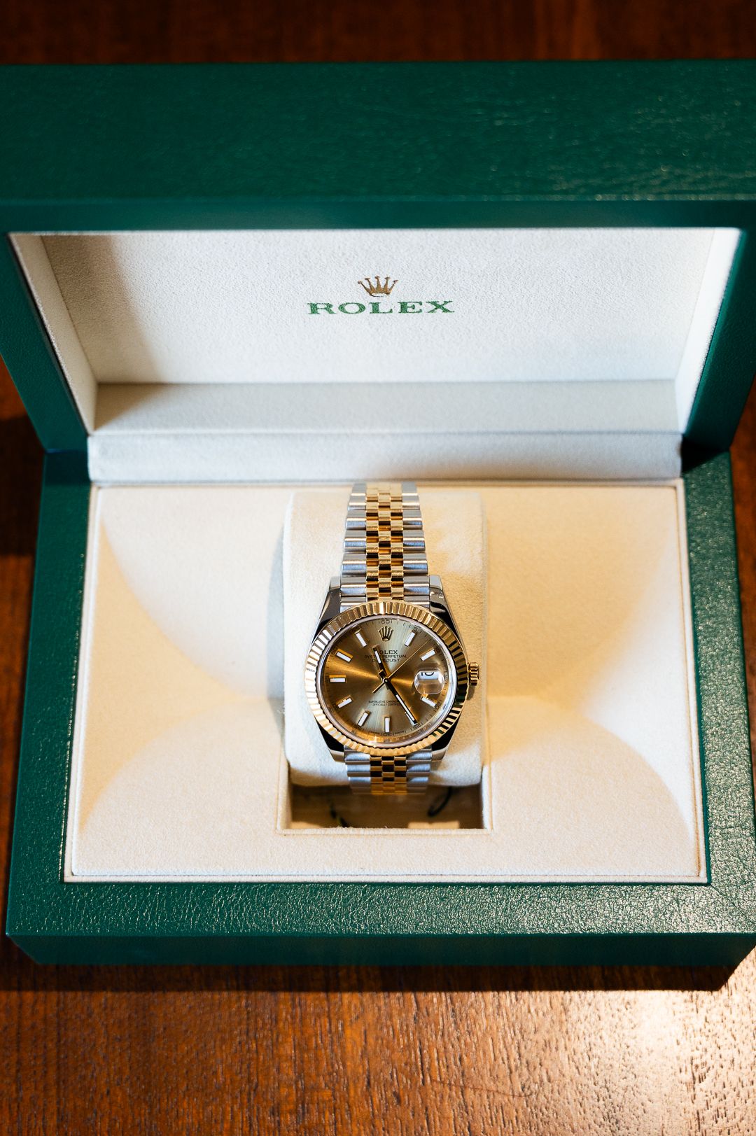Rolex watch presented in signature green leather presentation box with white interior.