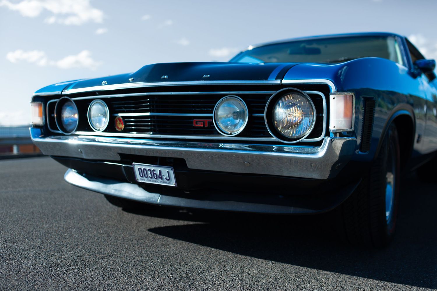 Classic Ford muscle car front end featuring iconic quad headlight design.
