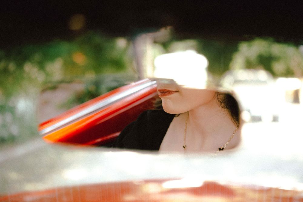 Picture of the lips in front of the mirror inside a mustang car. Casual Photo session