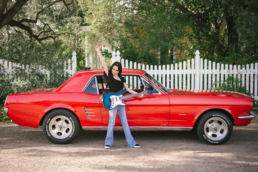 Girl playing a guitar next to a mustang Red. Memory Lane Photo Spot. Mission, Texas
