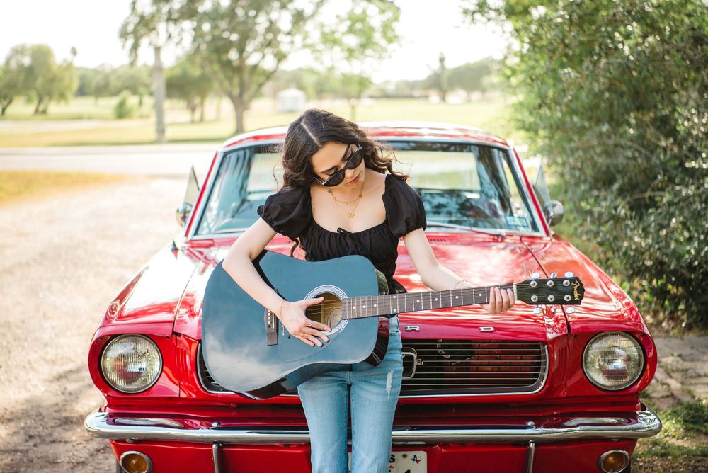 Quinceañera playing a guitar in front of red mustang. Memory Lane Photo Spot. Mission, Texas