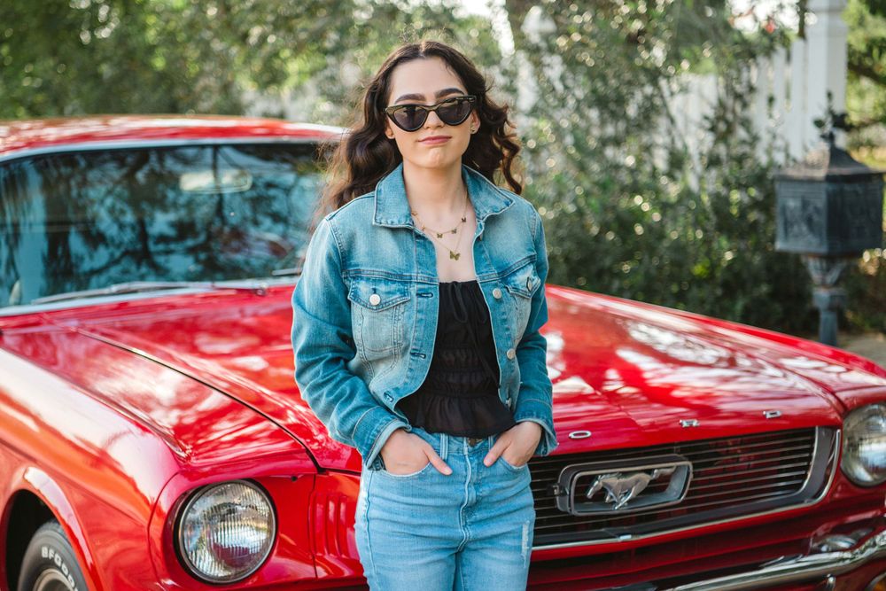 Girl standing in front of a red mustang. Memory Lane Photo Spot. Mission, Texas