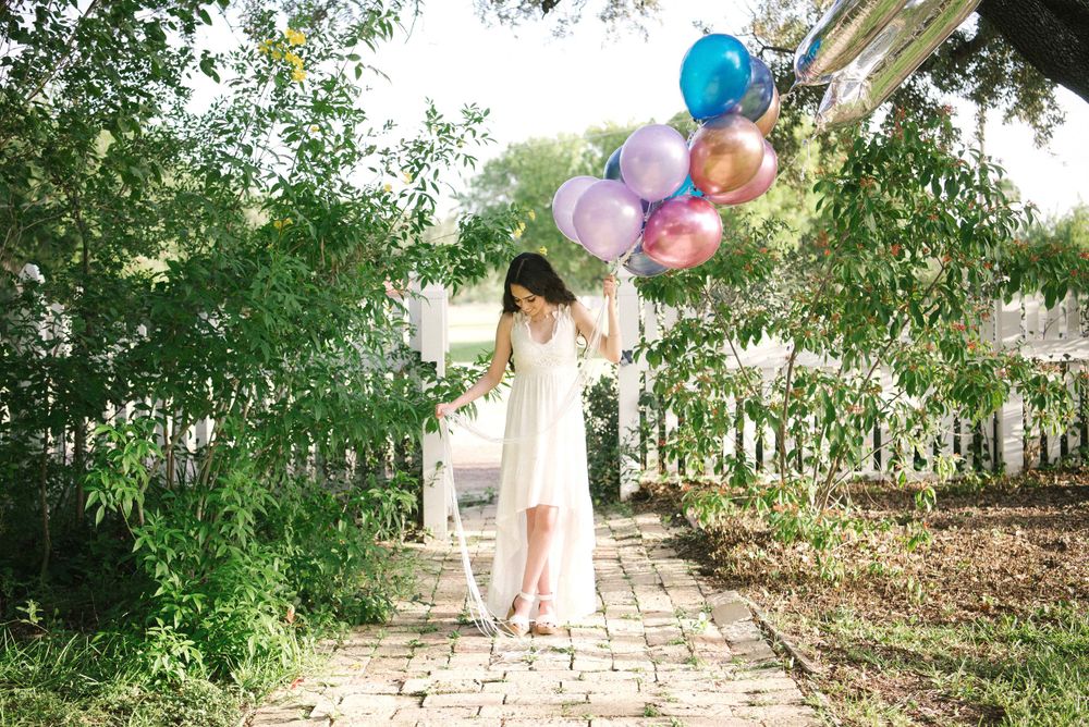 Beautiful girl walking down holding beautiful balloons. Memory Lane Photo Spot. Mission, Texas