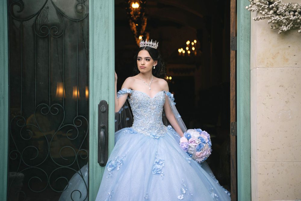 Beautiful quinceañera posing in a door at casa polonia in weslaco texas