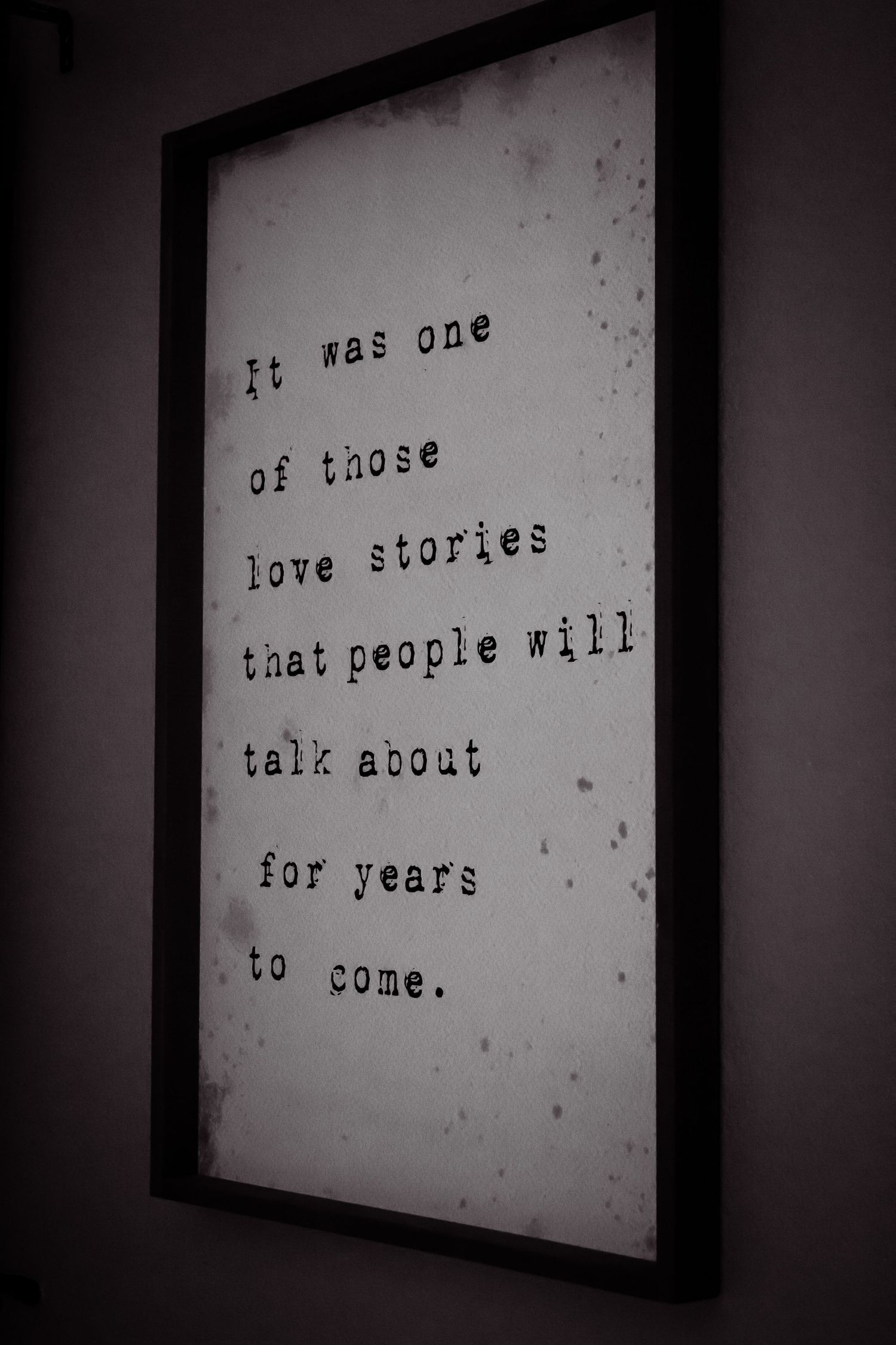 Black and white image of a sign that says, "it was one of those love stories that people will talk about for years."