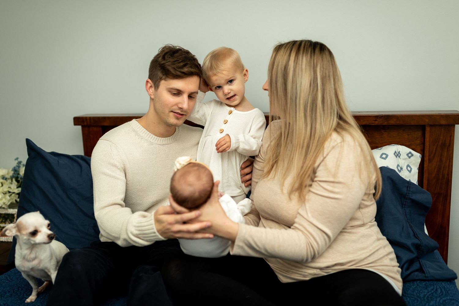 A family gathers together on their bed for quality time with their children.