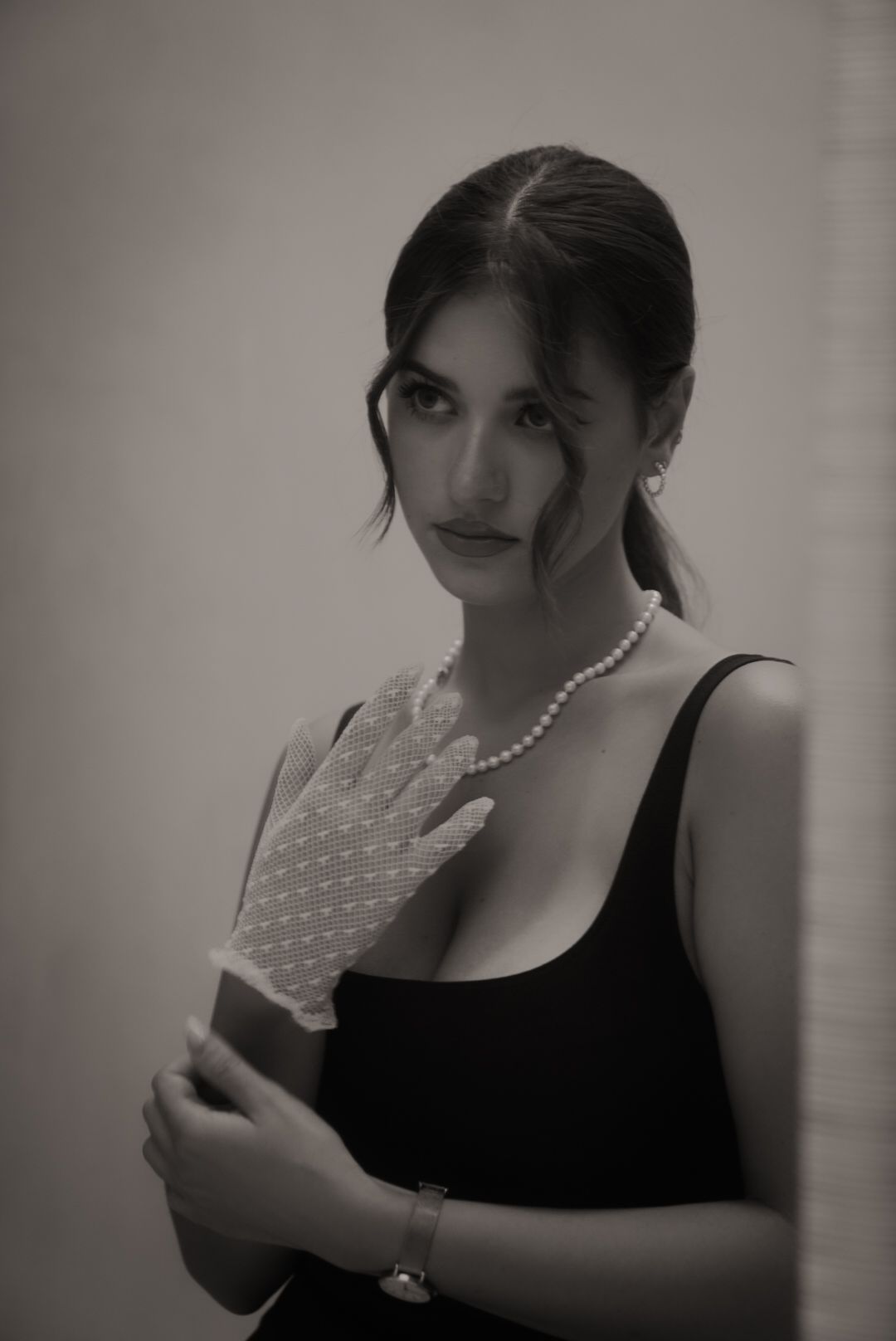 Classic black and white portrait with lace gloves and pearl necklace.