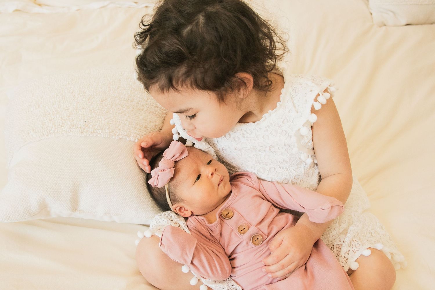 sibling posed photo kiss natural light bright