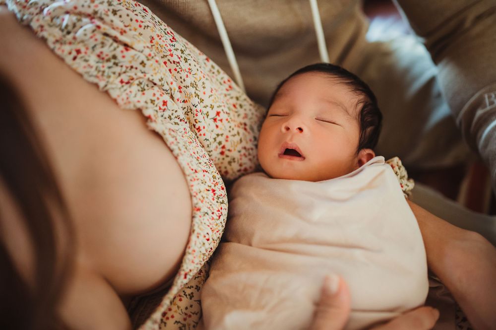 Mom snuggling her newborn baby.