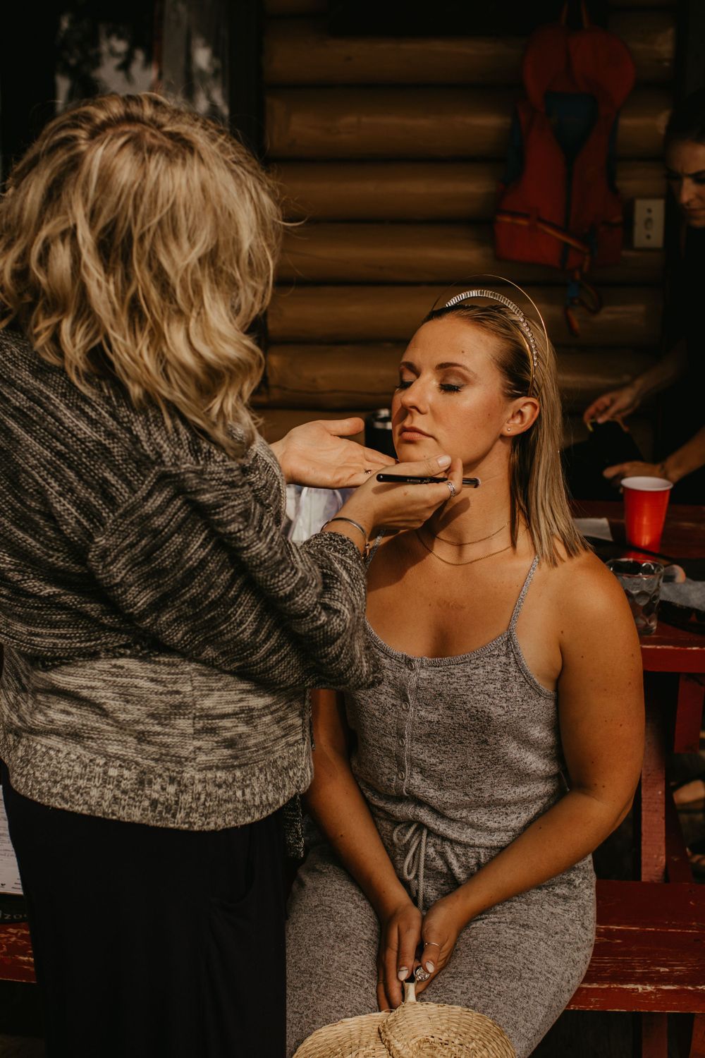 Makeup artist applying cosmetics during bridal preparation.