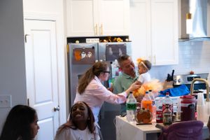 Kitchen gathering with autumn-themed party preparations and cooking activities.