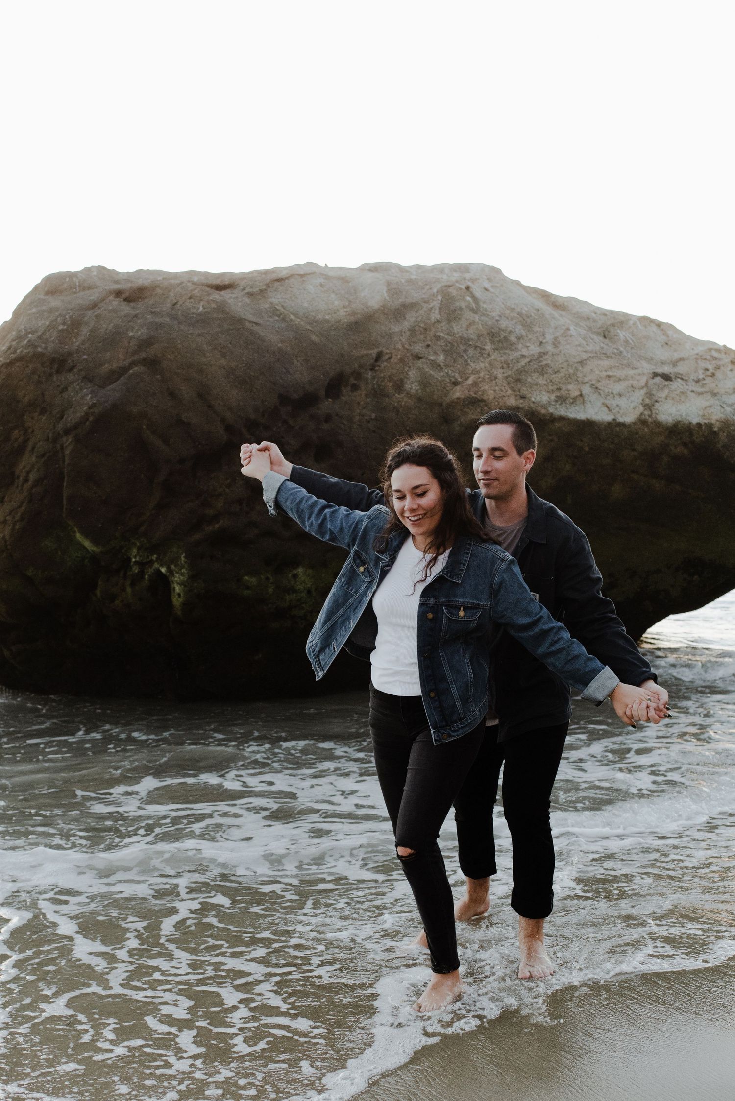 Couple plays along the shoreline at their Laguna Beach engagement shoot