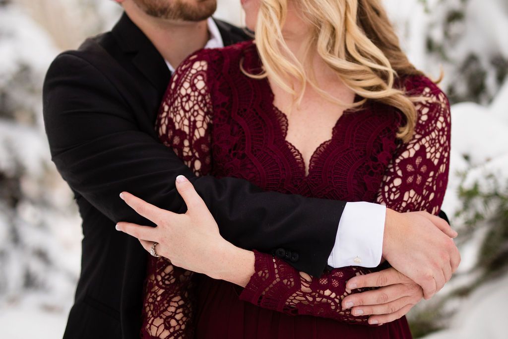 people snuggling in the snow.  mountain engagement session in the winter.  Utah mountains.