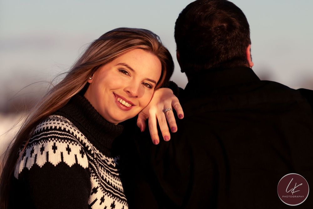 woman puts her head on her fiance's shoulder