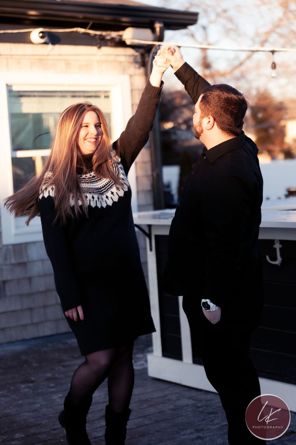engaged couple dances on deck of wickford on the water