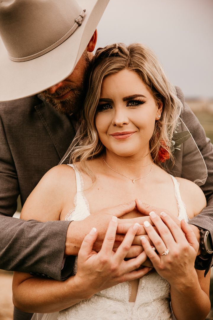 A romantic western-styled engagement portrait with rustic details and warm lighting.
