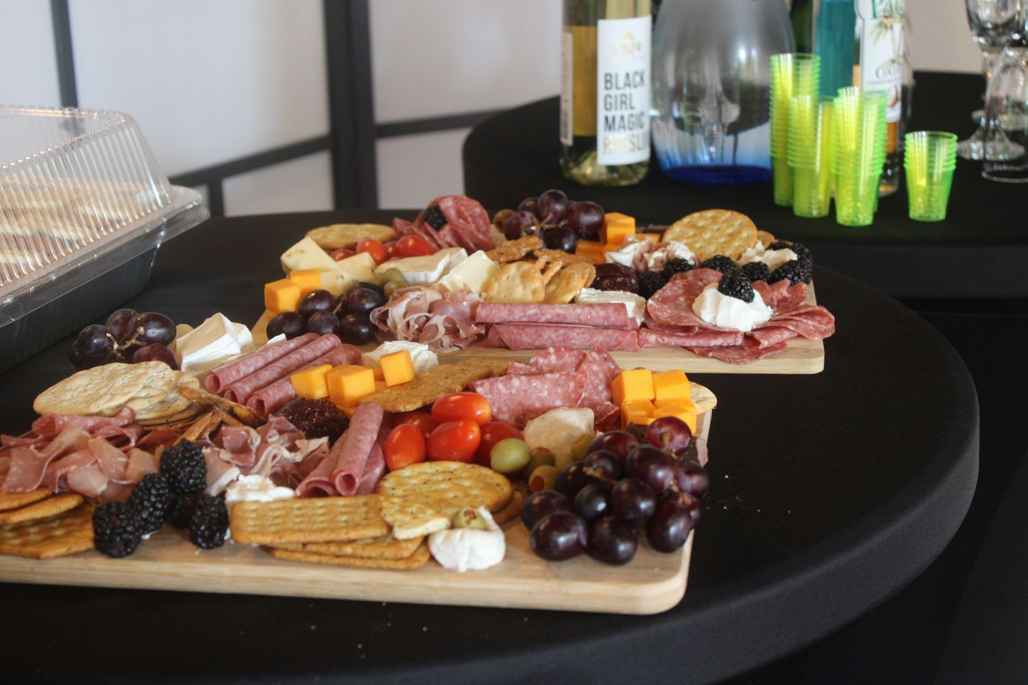 Gourmet charcuterie board with meats, cheeses, and fruits arranged on wooden serving platter.
