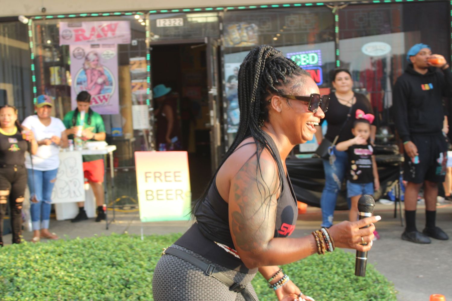 Person in athletic wear smiling and running during an outdoor event.