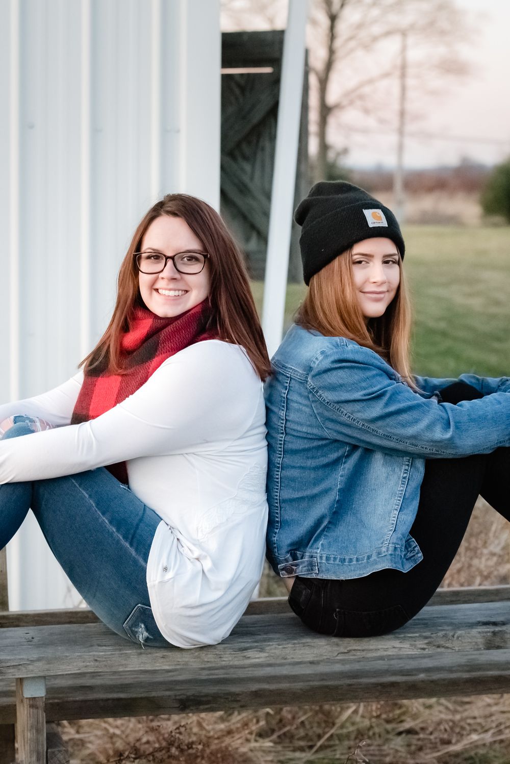 sisters best friends photo in an open field carhartt golden hour