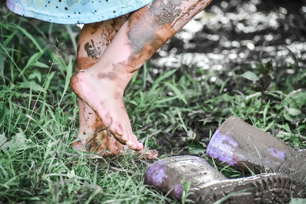bare feet kid playing in mud