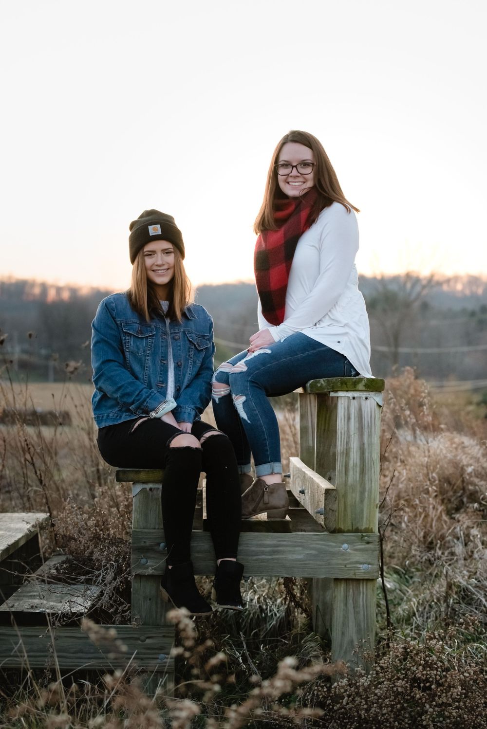 sisters best friends photo in an open field carhartt golden hour