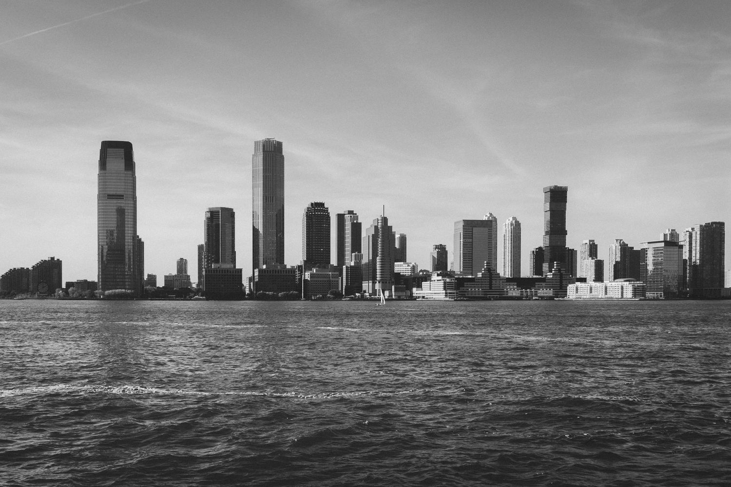 Black and white cityscape of Chicago skyline reflecting on Lake Michigan.