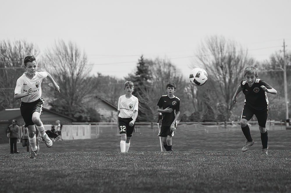 soccer players race for ball