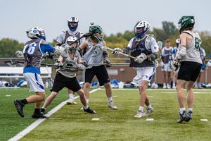 lacrosse players fight for ball