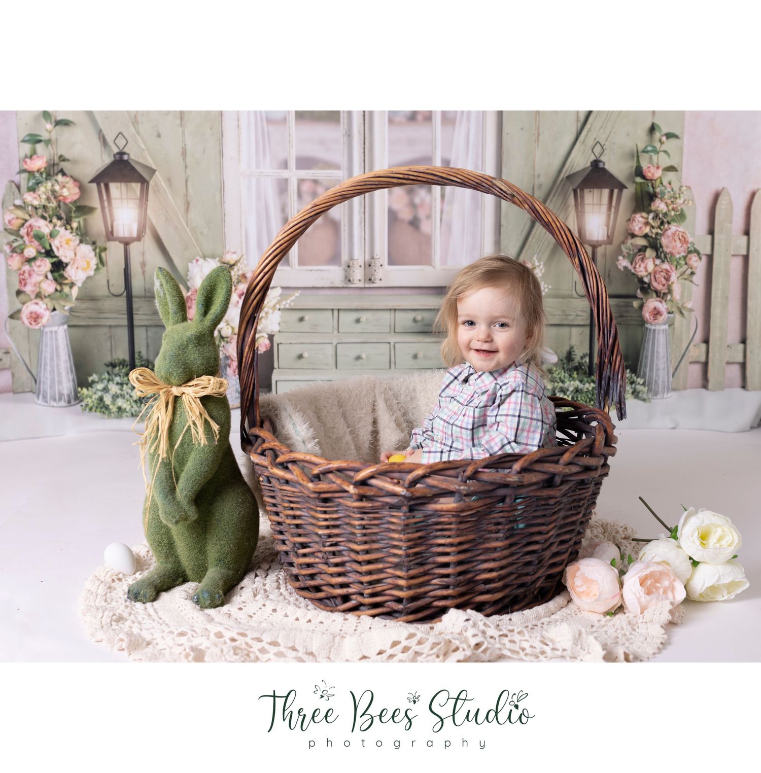 Spring themed photo with large basket and decorative green rabbit against floral backdrop.