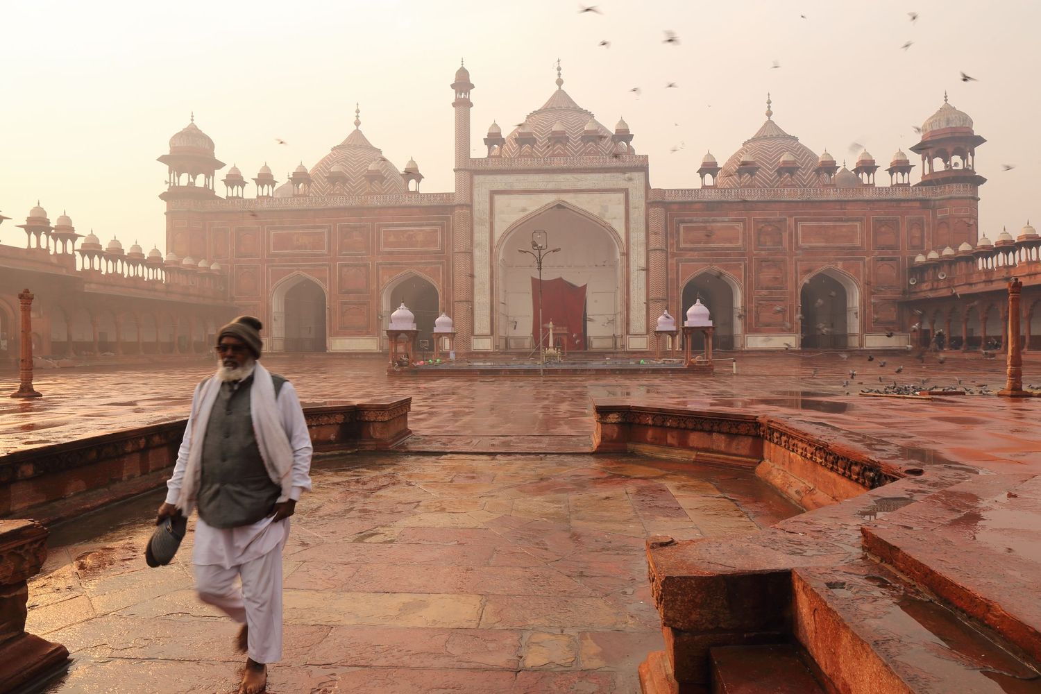 View of the historic Jama Masjid mosque in Delhi with its red sandstone architecture and courtyard.