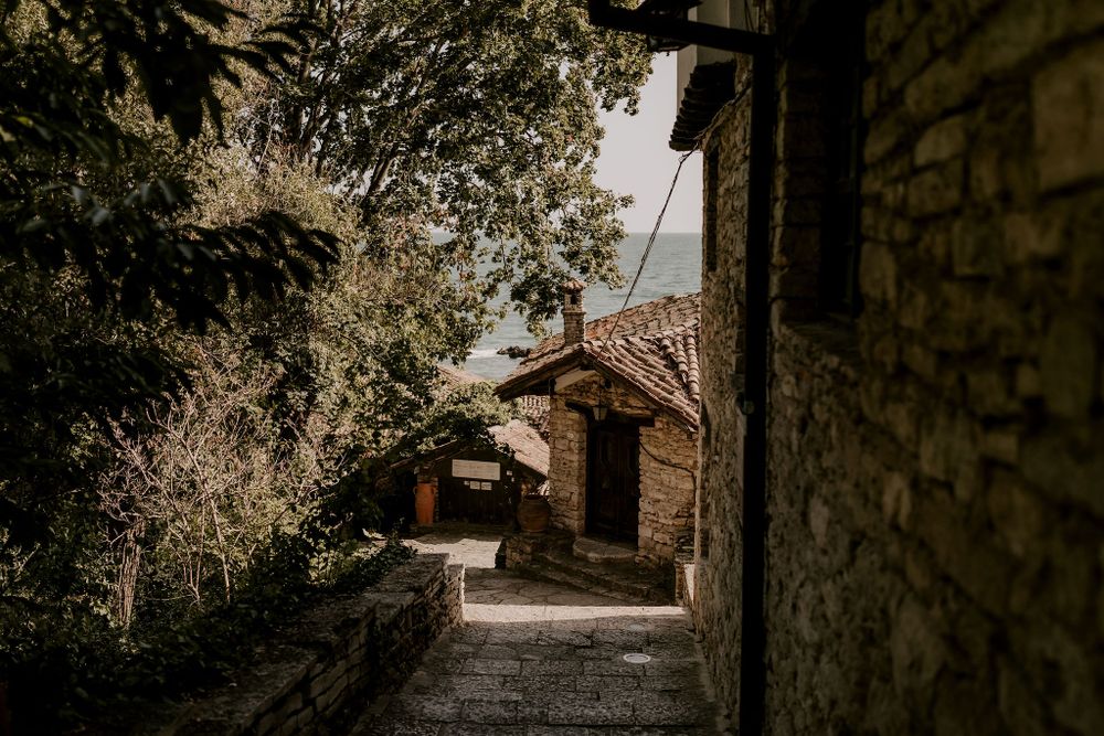 Stone archways and pathways create a rustic Mediterranean architectural scene.