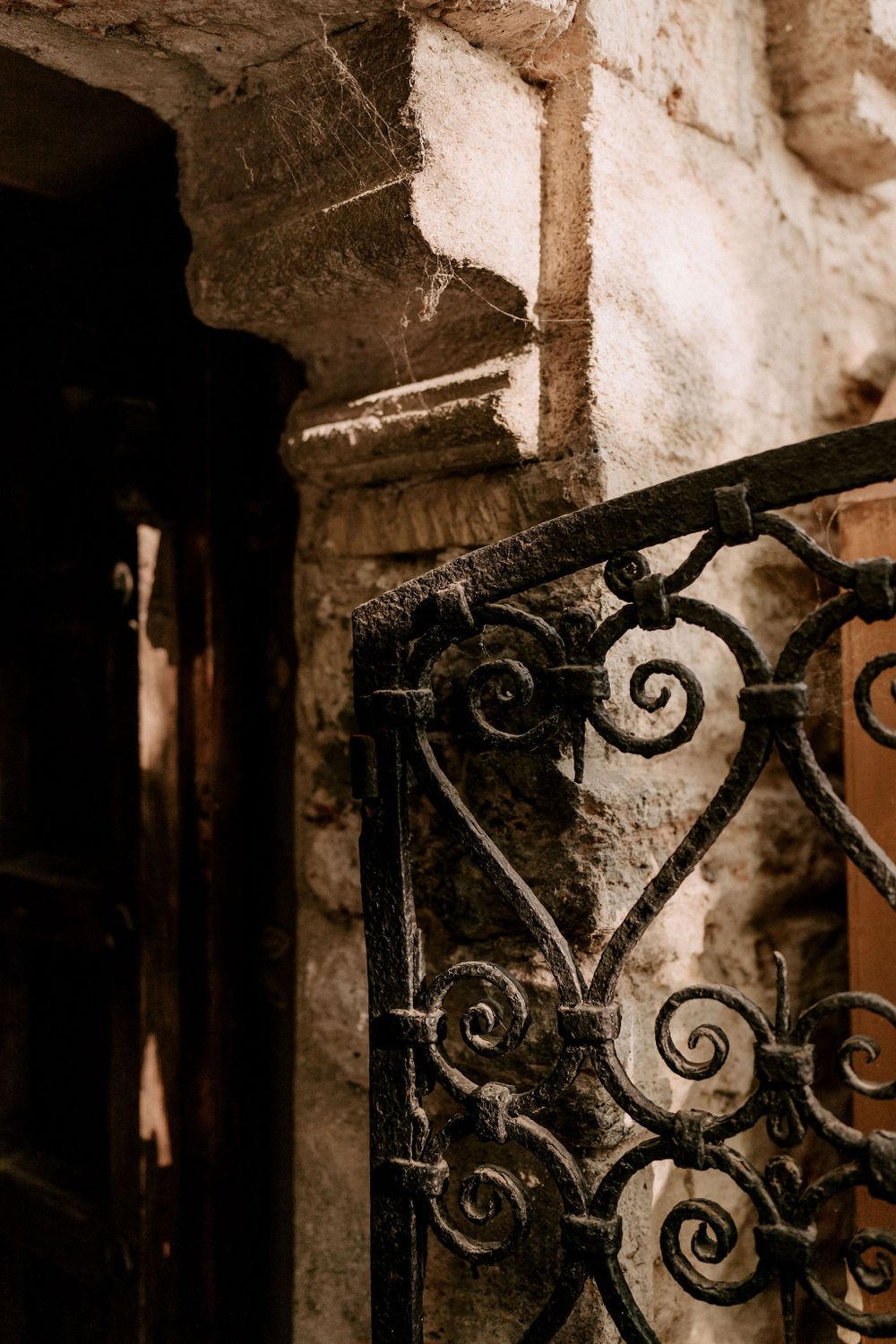 Ornate wrought iron details with scrollwork patterns in an antique setting.