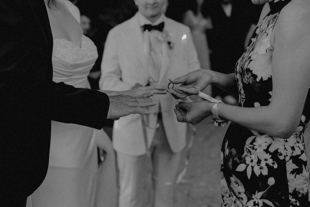 Wedding guests mingling during a reception in formal black and white attire.