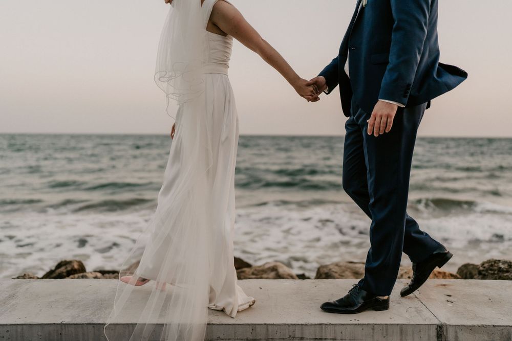 Elegant dance movements captured against coastal backdrop.