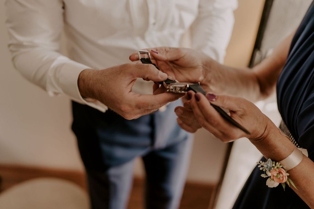 Close-up of hands exchanging rings during an intimate wedding ceremony.