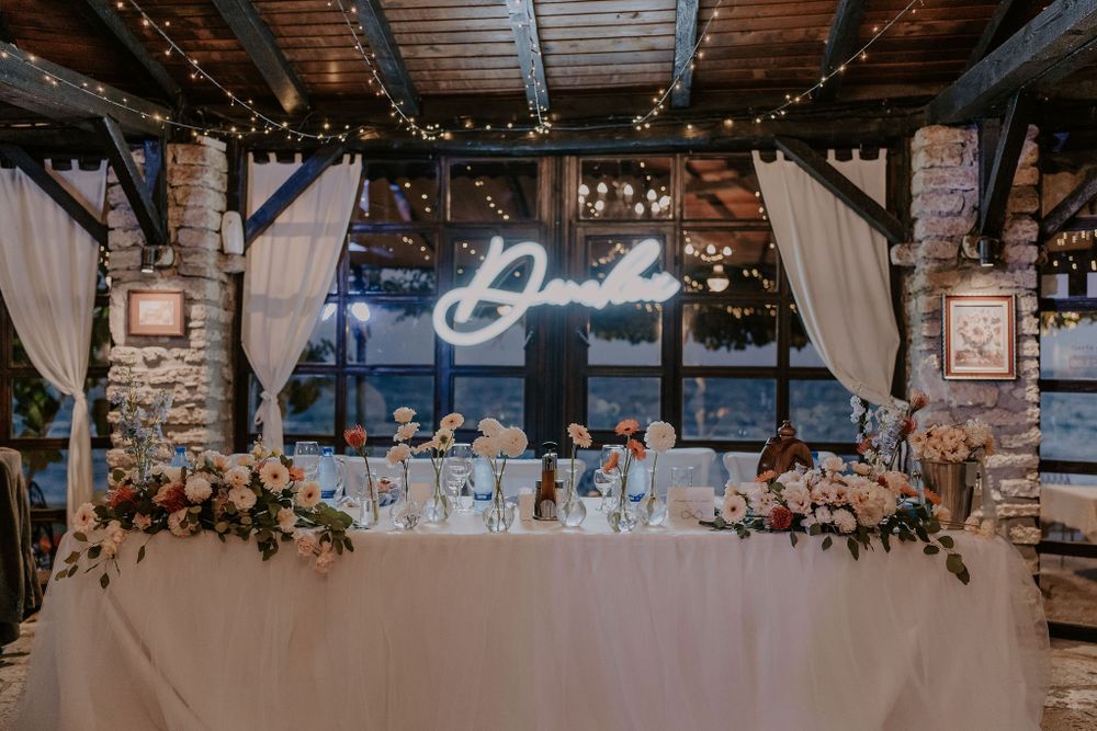 Rustic barn wedding venue with draped fabric and string light decorations.