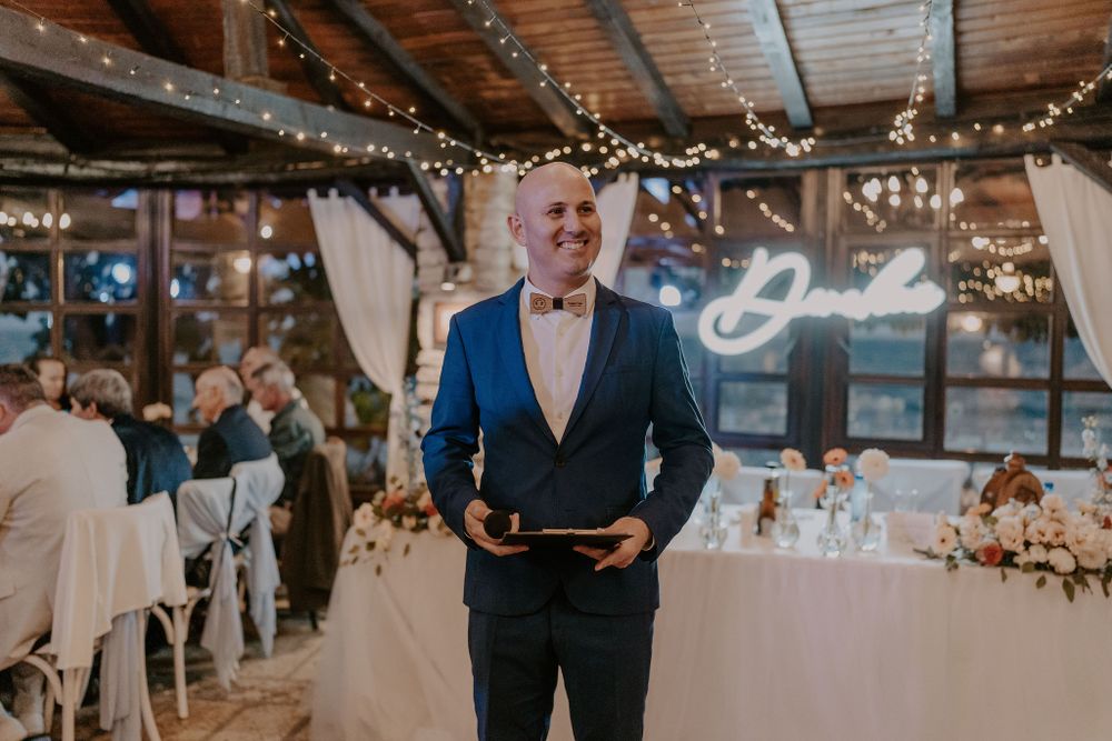 Wedding reception setup in a cozy barn venue with romantic lighting and table settings.